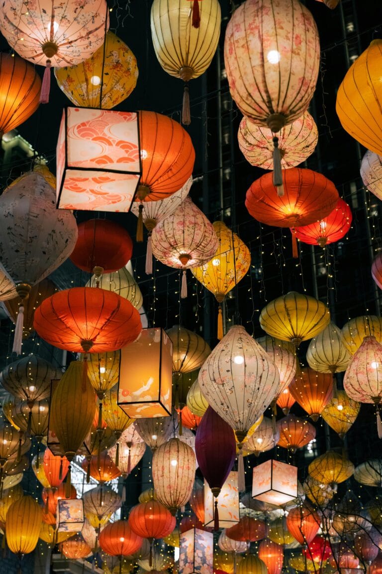Vibrant collection of hanging lanterns lighting up the night in a colorful festival display.