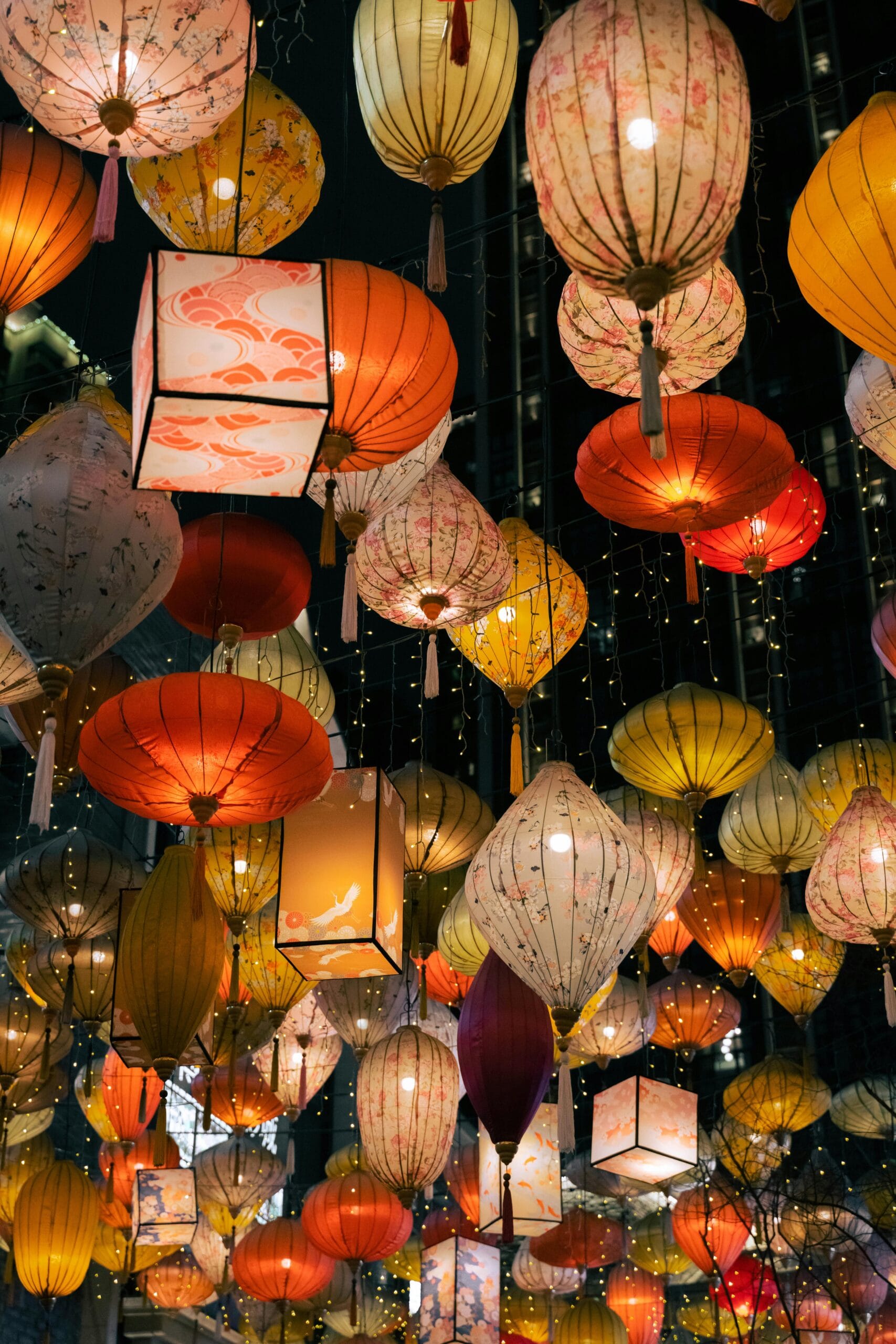 Vibrant collection of hanging lanterns lighting up the night in a colorful festival display.